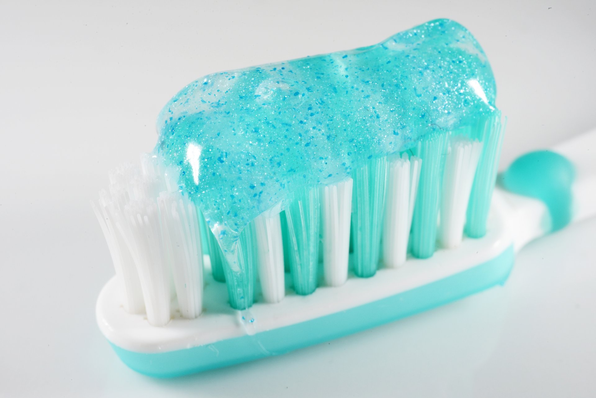 slither of toothpaste containing microbeads on a toothbrush