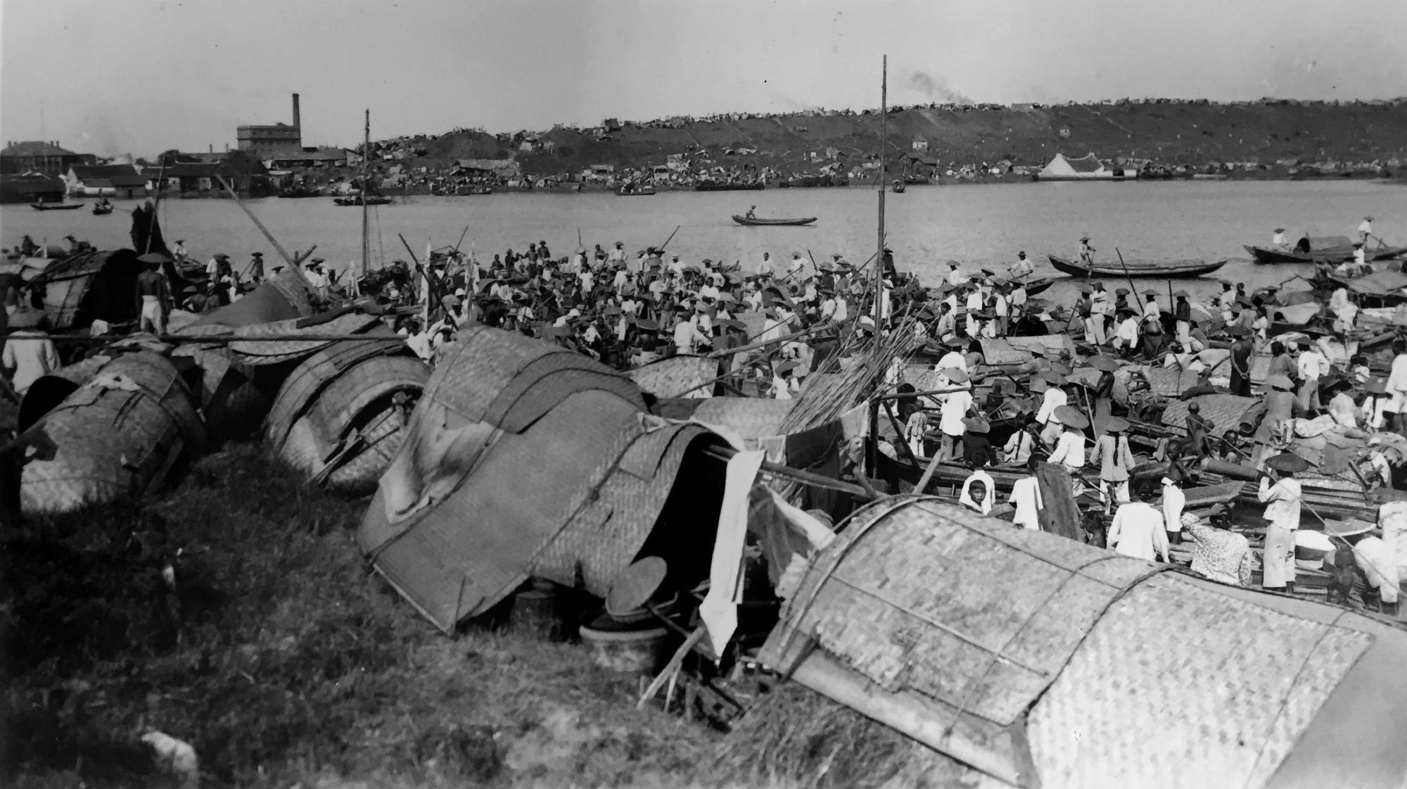 Reed huts in a refugee camp on the banks of the Han river