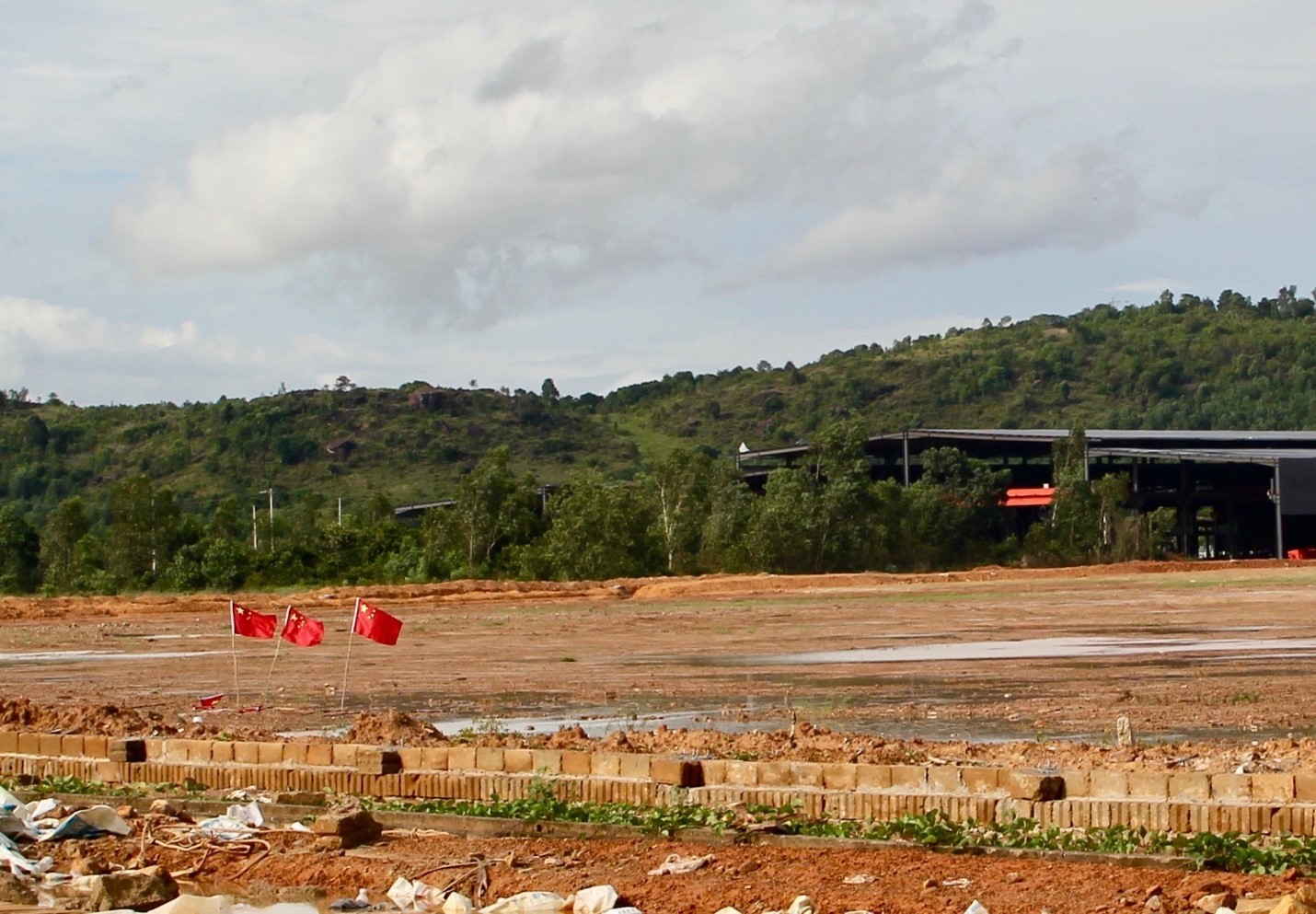 Chinese flags fly over an industrial lot under development in Sihanoukville (Image: Lili Pike)