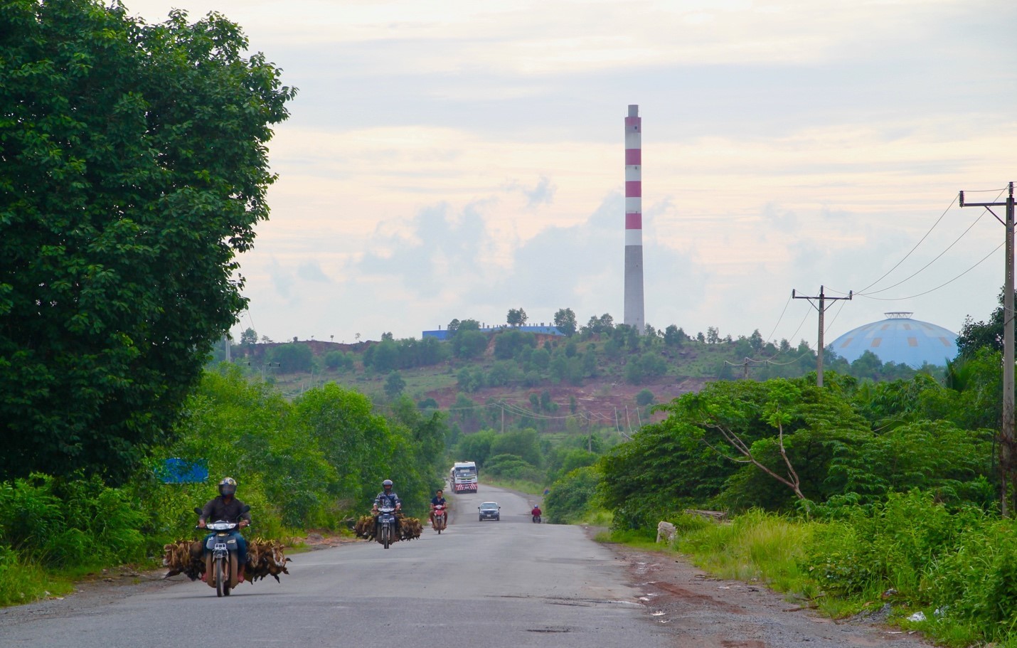 A smokestack rises over the hills of Sihanoukville, Cambodia (Image: Lili Pike)